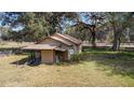 Exterior angle view of home with rustic siding and metal roof at 1213 Cr 652, Bushnell, FL 33513