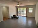 Open-concept living room with light walls, gray tile floors, and natural light at 22 Poinsettia Dr, Deland, FL 32724