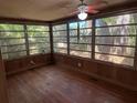 Bright sunroom with wood flooring and large windows at 22 Poinsettia Dr, Deland, FL 32724