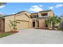 Modern two-story home with attached garage, brick accents, and palm tree landscaping at 229 Springside Rd, Longwood, FL 32779