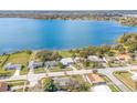 Aerial view of lakefront neighborhood with mature trees, green lawns and lake views at 250 Domino Dr, Orlando, FL 32805