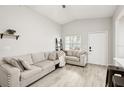 Bright living room with neutral tones, vaulted ceilings, and wood-look floors at 304 Dover St, Orlando, FL 32811