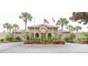 Welcoming community clubhouse featuring lush landscaping and prominent flag displays at 385 Wymore Rd # 200, Altamonte Springs, FL 32714