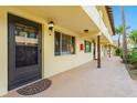 Exterior view of the condo complex with a door, light fixture, and walkway at 400 Oakridge Blvd # 5, Daytona Beach, FL 32118