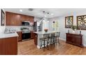 Kitchen with island breakfast bar, stainless steel appliances and granite countertops at 43 Pergola Pl, Ormond Beach, FL 32174