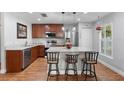 Kitchen island with breakfast bar, stainless steel appliances and granite countertops at 43 Pergola Pl, Ormond Beach, FL 32174