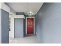 A charming entryway with a red front door and neutral tones at 4515 Sea Biscut Ct, Orlando, FL 32818