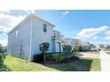 A charming view of a two-story home, showing the well-maintained garden, lawn, and the paved driveway at 5030 Tibet Ct, St Cloud, FL 34772