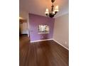 Dining area with wood flooring, chandelier, and a view into the kitchen at 6250 S Bend Sq # 17, Orlando, FL 32807