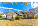 Charming single-Gathering home featuring brick and siding accents, attached garage, and landscaped front yard at 762 Lake Como Dr, Lake Mary, FL 32746