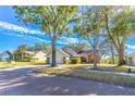 Charming single-Gathering home with brick and siding accents and an attached garage, nestled on a tree-lined street at 762 Lake Como Dr, Lake Mary, FL 32746