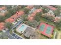 Aerial view showcasing community amenities: a pool, clubhouse, and tennis courts at 7709 Sundial Ln, Orlando, FL 32819