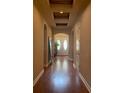 Inviting hallway featuring hardwood floors, archways, and a double-door entryway with transom windows at 8908 Via Bella Notte, Orlando, FL 32836