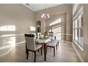 Bright dining room featuring modern table set, neutral walls, wood-style tile floor, and large window at 13330 Meergate Cir, Orlando, FL 32837