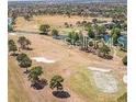 Expansive aerial view of the golf course, with manicured greens and mature tree lined fairways at 13941 Fairway Island Dr # 733, Orlando, FL 32837