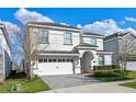 Charming two-story home with a well-manicured lawn and a striking blue front door at 1585 Plunker, Davenport, FL 33896