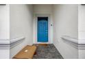 Inviting entryway featuring a bright blue front door and a welcoming bench at 1585 Plunker, Davenport, FL 33896