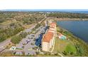 An elevated aerial view showing the pool, parking and exterior of the condo building at 16300 County Road 455 # 712, Montverde, FL 34756