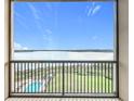 Balcony with view of lake, pool, and landscaped grounds at 16300 County Road 455 # 712, Montverde, FL 34756