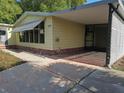 Charming single-story home with a covered carport and an expansive concrete driveway at 1765 W Schwartz Blvd, Lady Lake, FL 32159