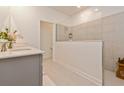 Bathroom featuring a glass shower and double sinks at 1908 Perch Hammock Loop, Groveland, FL 34736