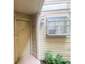 Exterior entrance featuring a security camera, warning sign, and neutral-colored door at 1932 Lake Atriums Cir # 77, Orlando, FL 32839