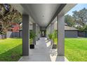 Unique walkway framed by modern columns and lush landscaping, leading to the main entrance at 2010 Hoffner Ave, Belle Isle, FL 32809