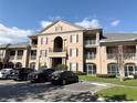 Condo building showcasing its detailed architecture and landscaping under a bright sky at 2013 Tizewell Cir # 1408, Orlando, FL 32837