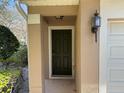 Close up of front door with side sconce at 2511 Metro Sevilla Dr # 101, Orlando, FL 32835