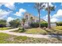 Beautiful home with palm trees, a well-manicured lawn, and a spacious driveway at 2806 Baywood Ln, Kissimmee, FL 34746