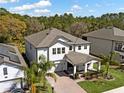 Aerial view of a beautiful two-story home with a spacious backyard and mature trees at 3245 Upland Pt, Oviedo, FL 32765