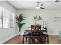 Bright dining room with hardwood floors, modern fan, and view to adjacent rooms at 328 Lake Fair Ln, Winter Park, FL 32789