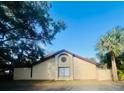 Architectural home showcasing stucco siding, a red tile roof, and large arched window design at 426 Club Dr, Winter Springs, FL 32708