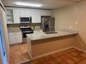 Bright kitchen with stainless steel appliances, white cabinets, and granite countertops at 5286 Willow Ct # 505, Orlando, FL 32811