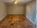 Spacious living room featuring tile floors, a ceiling fan, and sliding glass doors at 5286 Willow Ct # 505, Orlando, FL 32811