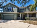 Charming two-story home with a covered porch, a two-car garage and a well-maintained lawn at 602 Lochsmere Ln, Orlando, FL 32828