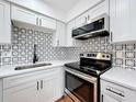 Updated kitchen with stainless steel appliances and a patterned backsplash at 606 Casa Park I Court, Winter Springs, FL 32708