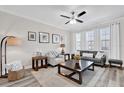 Comfortable living room featuring neutral colors, modern decor, and plenty of natural light from the large windows at 6132 Saint Julian Dr, Sanford, FL 32771