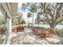 Covered patio with comfortable seating and views of the tranquil lake at 632 Tranquil Oaks Ln, Oviedo, FL 32765