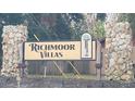 Richmoor Villas community sign featuring stone pillars and a decorative logo at 7411 Golden Glenn Ct, Orlando, FL 32807