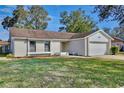 Inviting single-story home with a neat front lawn and an attached garage offers suburban charm at 9913 Peddlers Way, Orlando, FL 32817