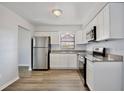 Bright kitchen with stainless steel appliances, granite countertops, and modern white cabinetry at 9913 Peddlers Way, Orlando, FL 32817