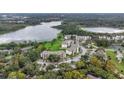 An aerial view showcasing the condo complex surrounded by lush trees, lakes, and parking at 1060 Lotus Pkwy # 1012, Altamonte Springs, FL 32714