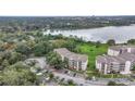 Aerial view of a condo complex near a lake with ample parking and lush greenery at 1060 Lotus Pkwy # 1012, Altamonte Springs, FL 32714