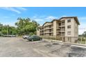 Condo building featuring multiple balconies, ample parking, and a well-maintained exterior at 1060 Lotus Pkwy # 1012, Altamonte Springs, FL 32714