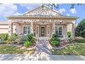 Inviting front porch with decorative landscaping and a brick walkway leading to the front door at 1112 Heron Point Way, Deland, FL 32724