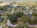 An aerial shot displays the property, nestled among mature trees, in a tranquil residential neighborhood setting at 1221 Forest Cir, Altamonte Springs, FL 32714