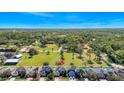 Wide aerial view of a residential area with homes and green spaces under a clear blue sky at 137 Kays Landing Dr, Sanford, FL 32771