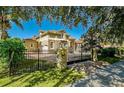 Gated entrance leading to a landscaped property with mature trees and lush greenery at 1502 Hempel Ave, Windermere, FL 34786