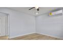 A neutral bedroom featuring attractive flooring, clean trim, a ceiling fan and AC unit at 19 N Van Buren Ave, Orlando, FL 32811